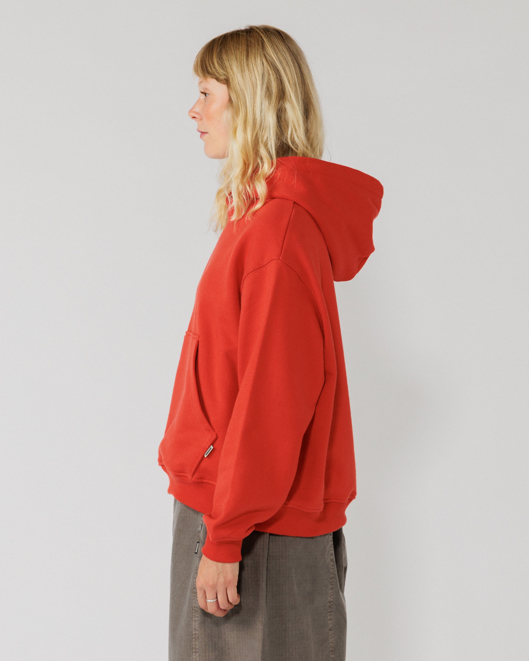 520 Organic Hoody - Signal Red — women's side, sleeve drape