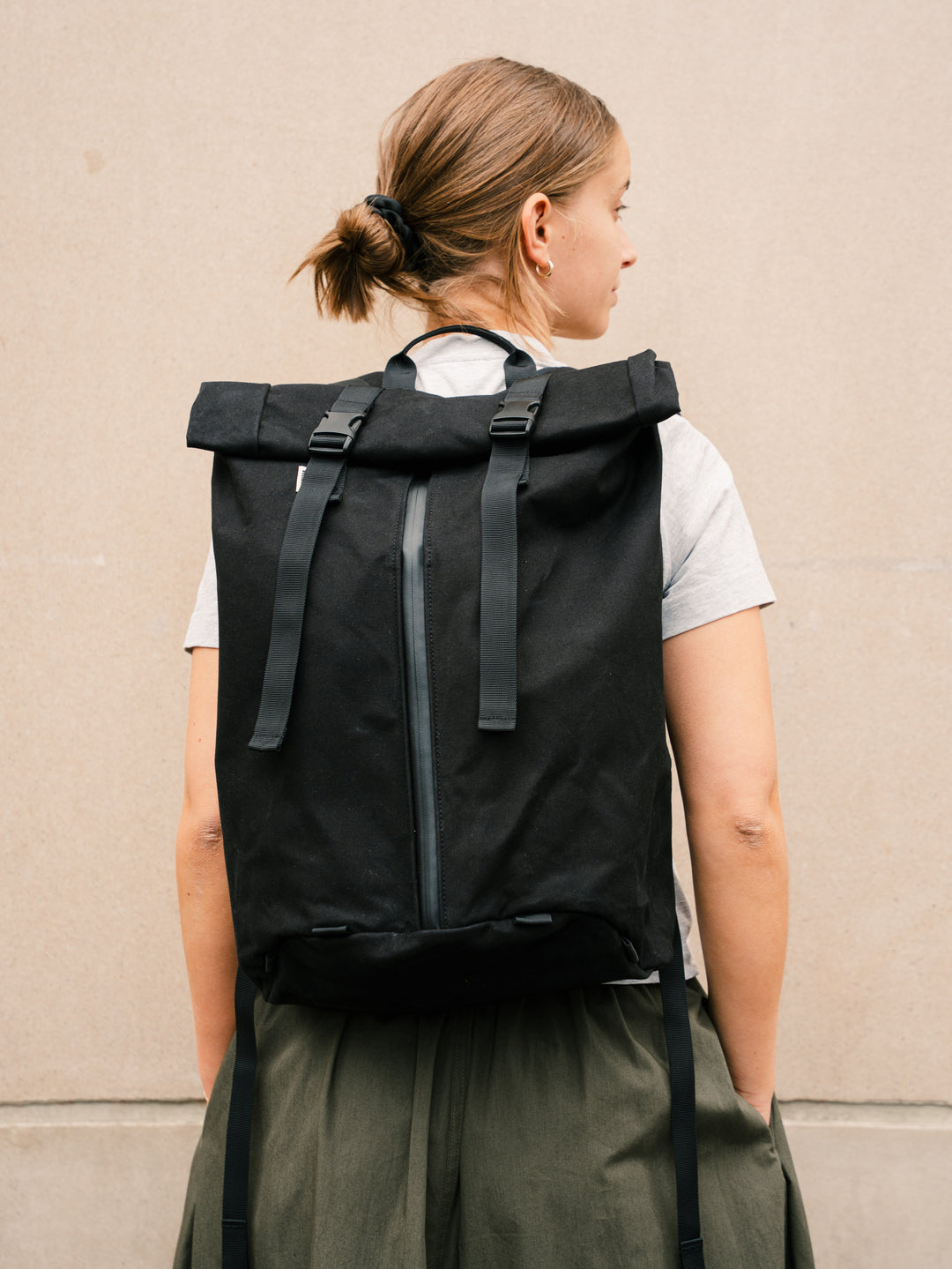 Bridge Backpack in Black worn on model, back view