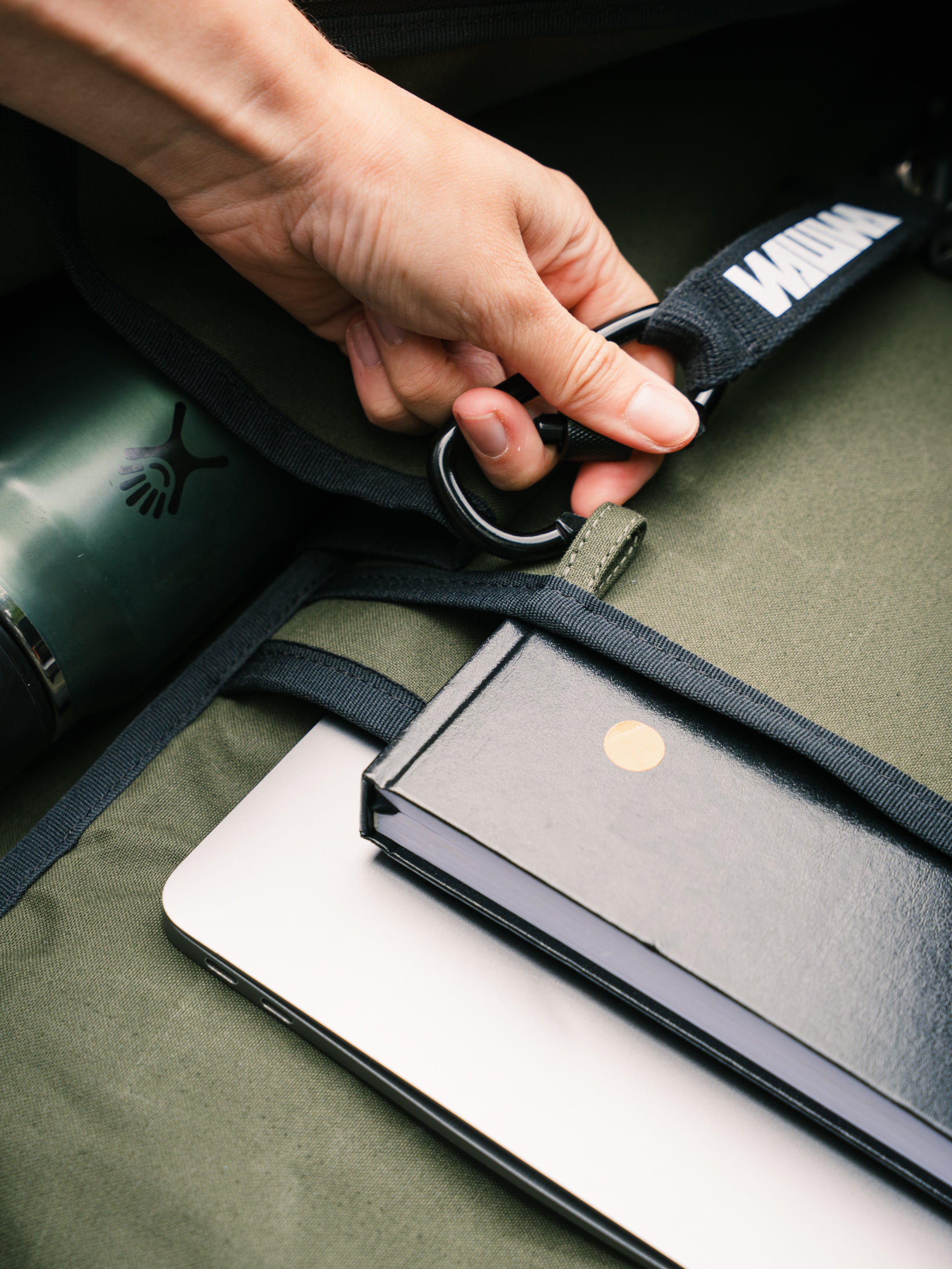 Carabiner key strap and laptop sleeve inside the Bridge Backpack in Khaki Green