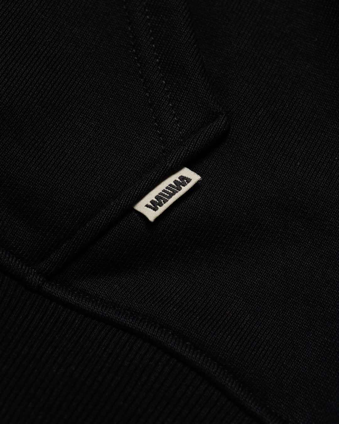 Heavyweight Two-Way Zip Hoody - Black — Hem label branding detail