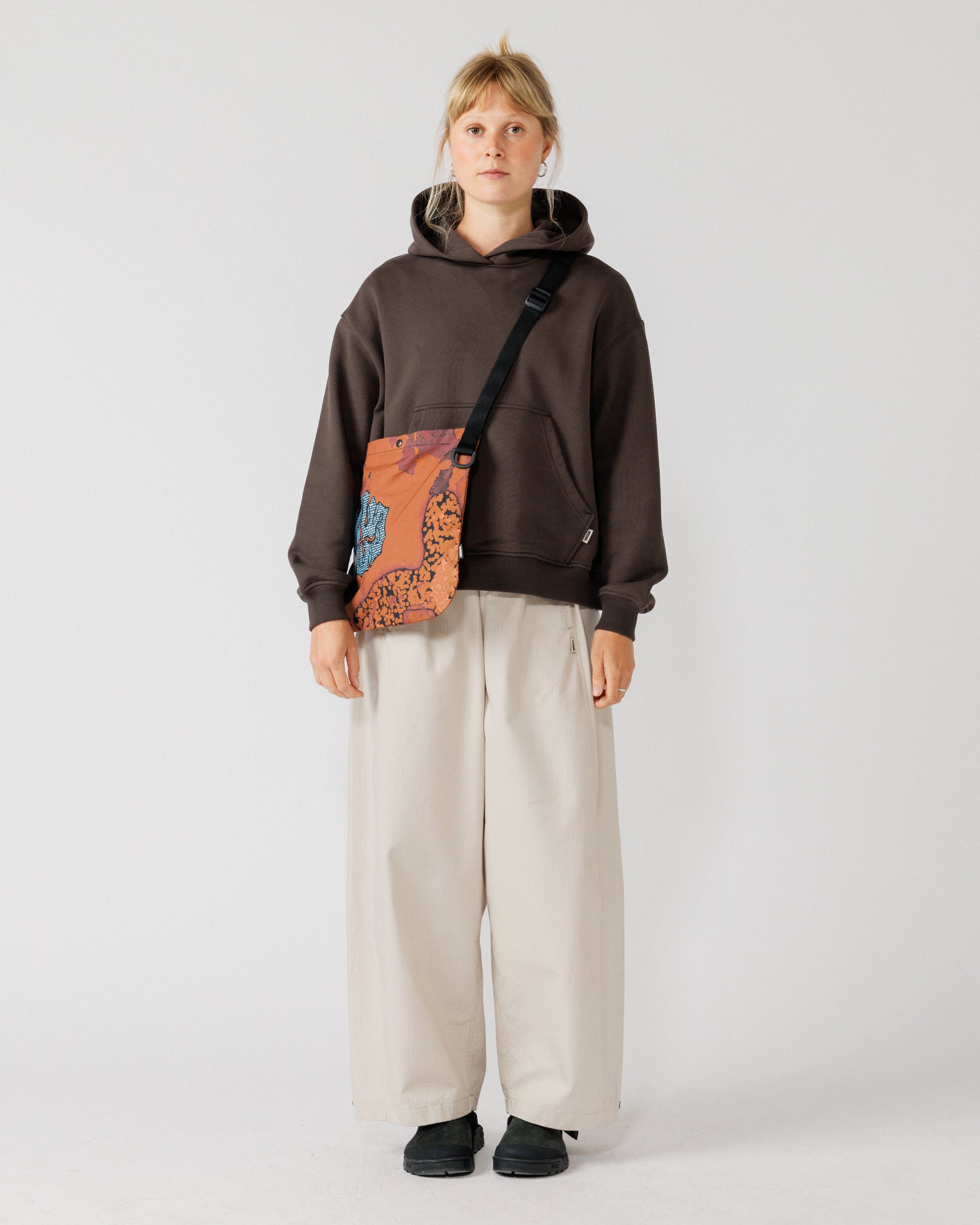 Musette - Abstract Brick Camo — worn front, bag centred