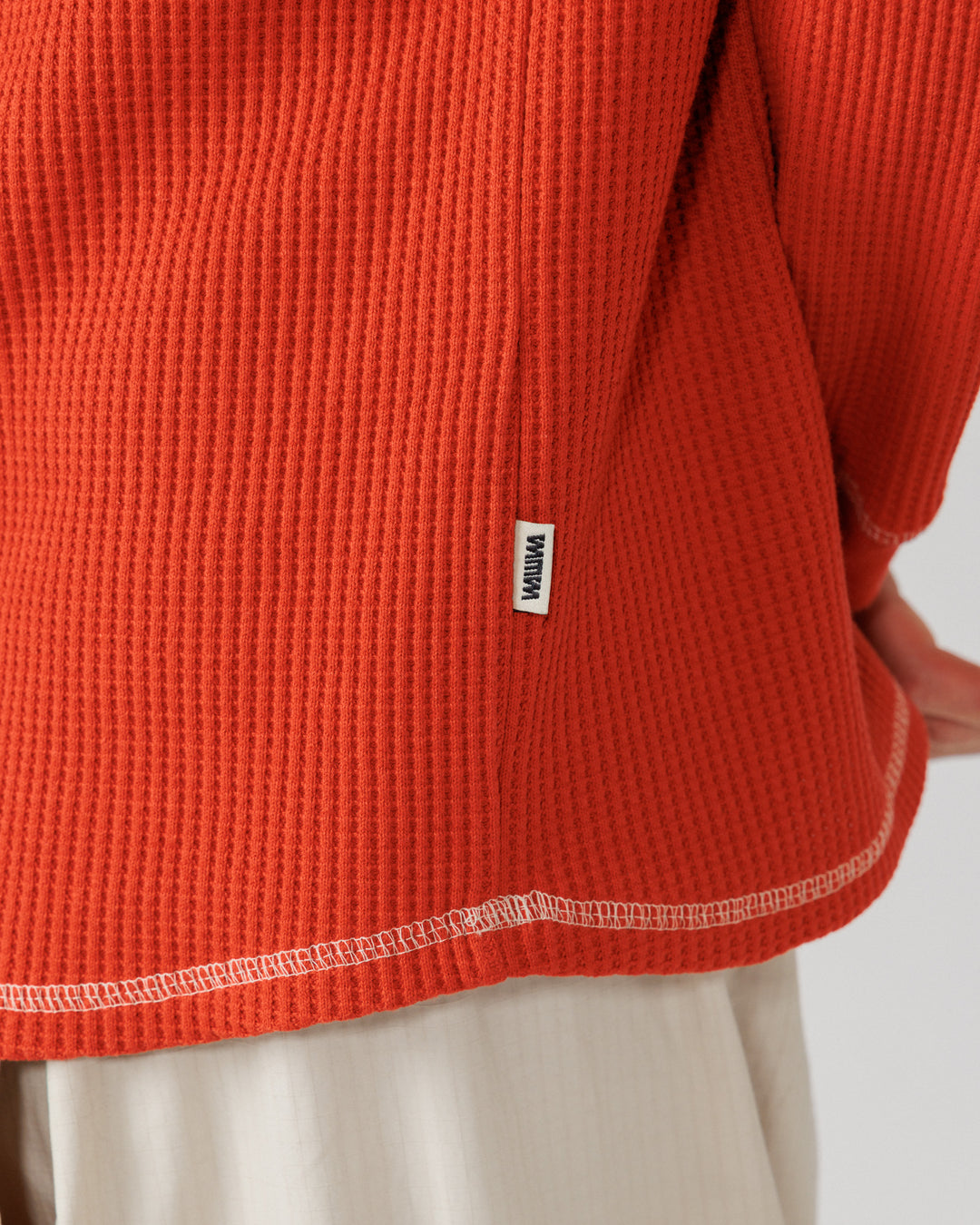Raglan Range Waffle Knit - Signal Red w Ecru — hem, label and texture