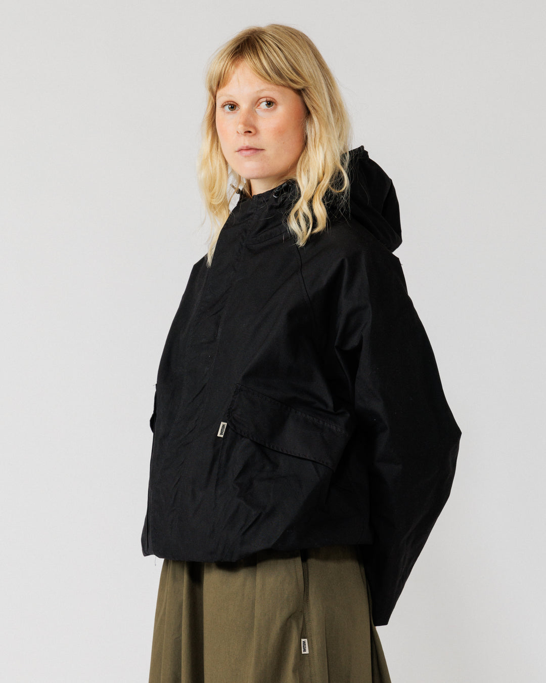 Roam Raglan Jacket - Black — female three-quarter angle, adds variety
