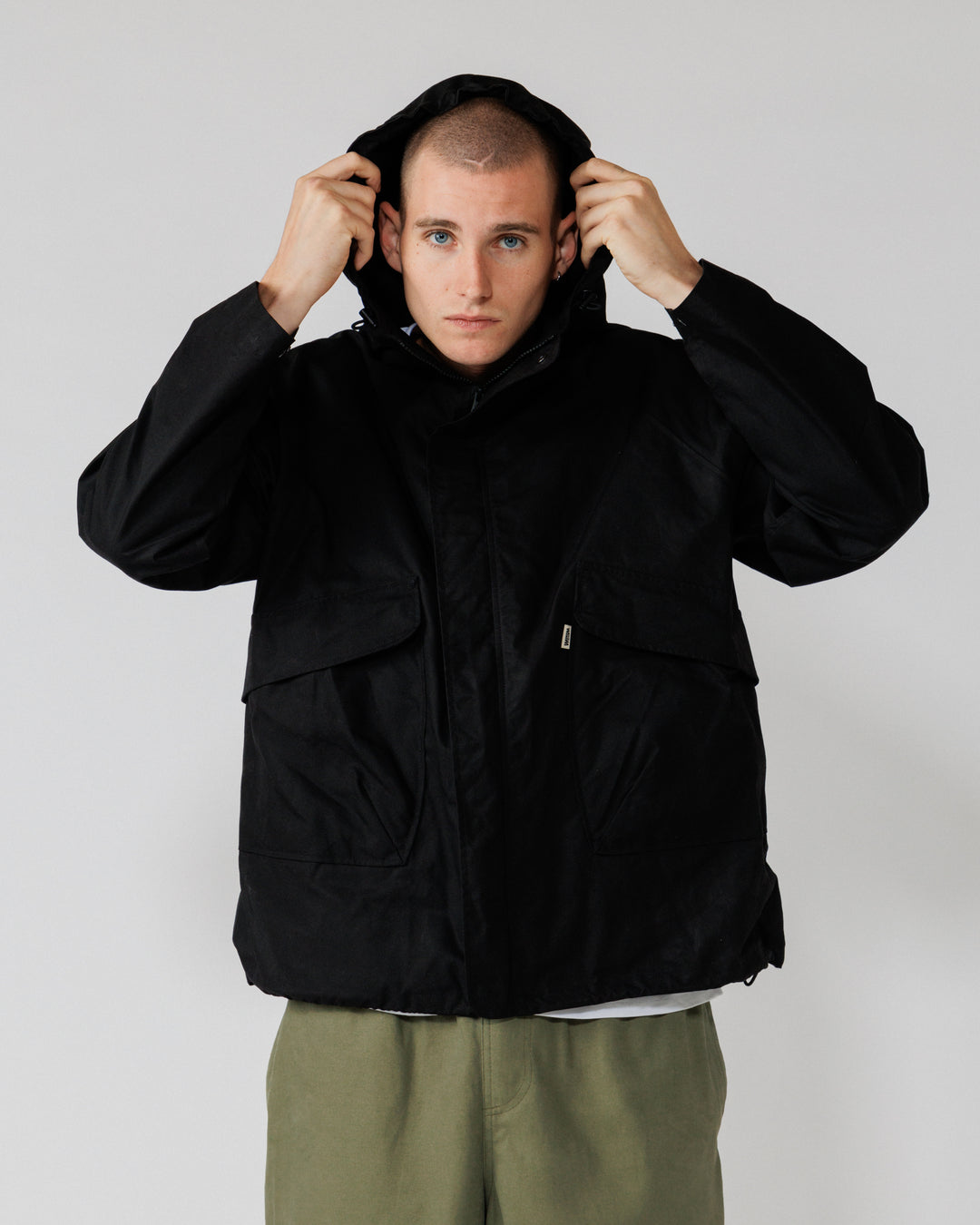 Roam Raglan Jacket - Black — hood-up action, shows function