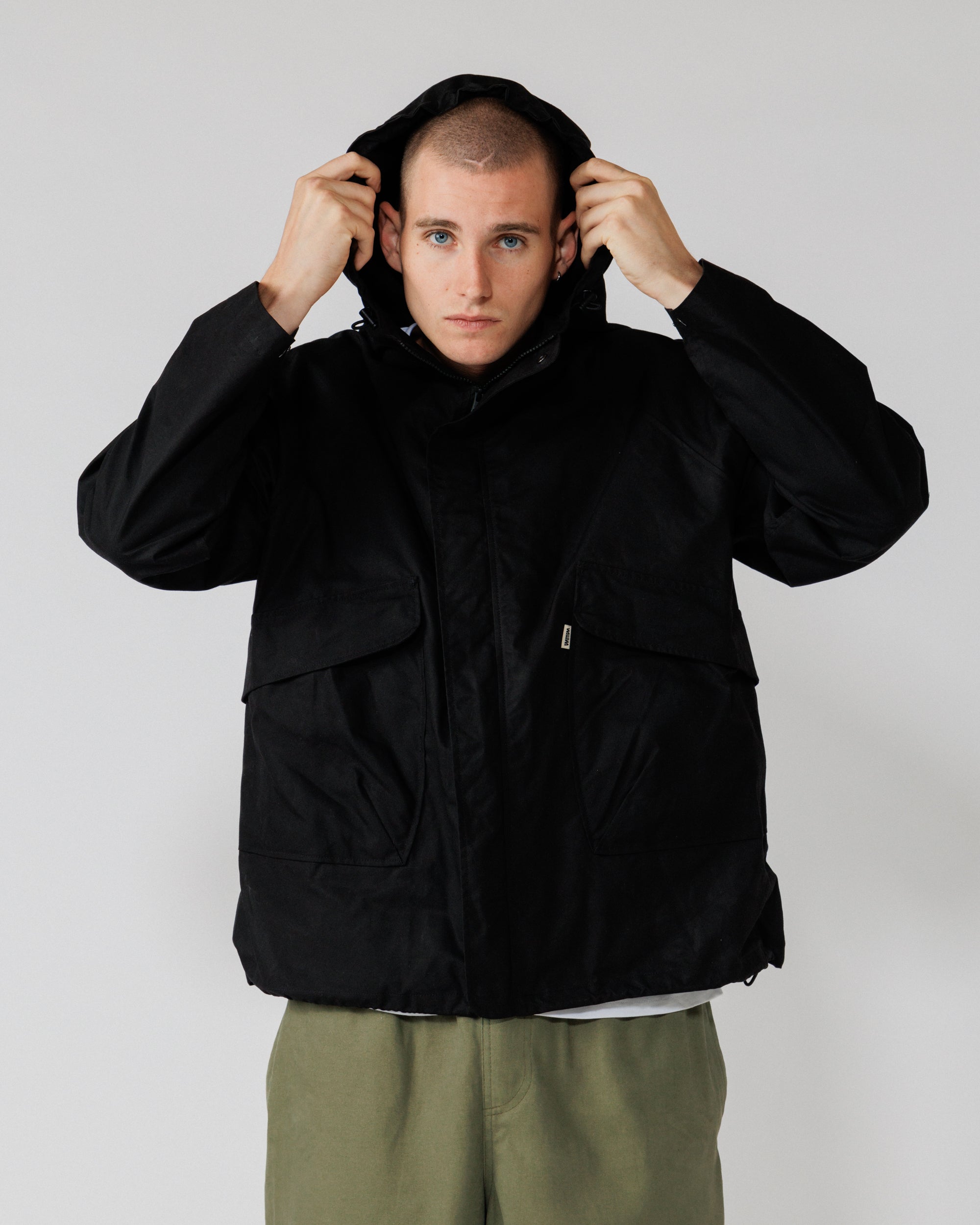 Roam Raglan Jacket - Black — hood-up action, shows function