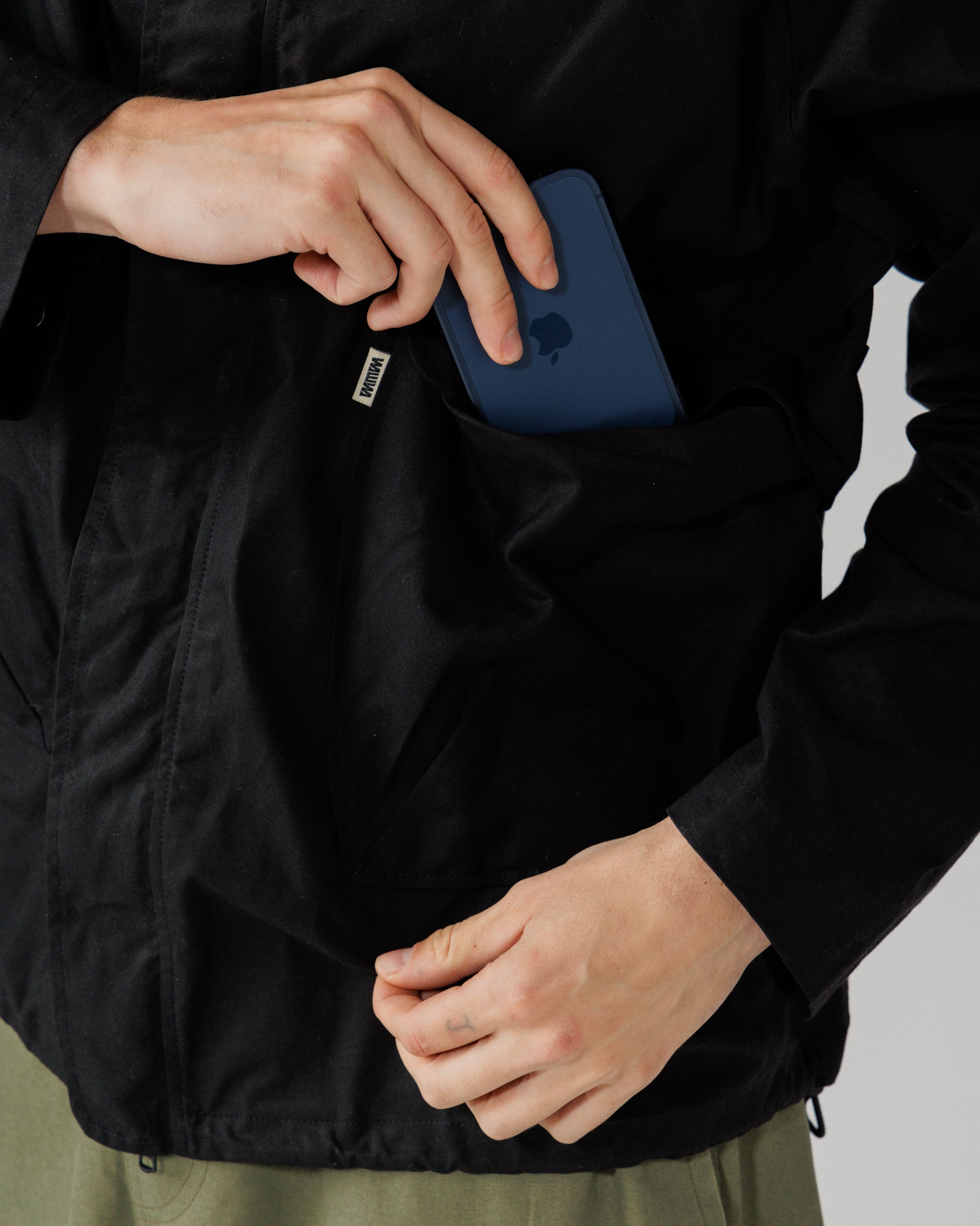 Roam Raglan Jacket - Black — flap pocket capacity demo