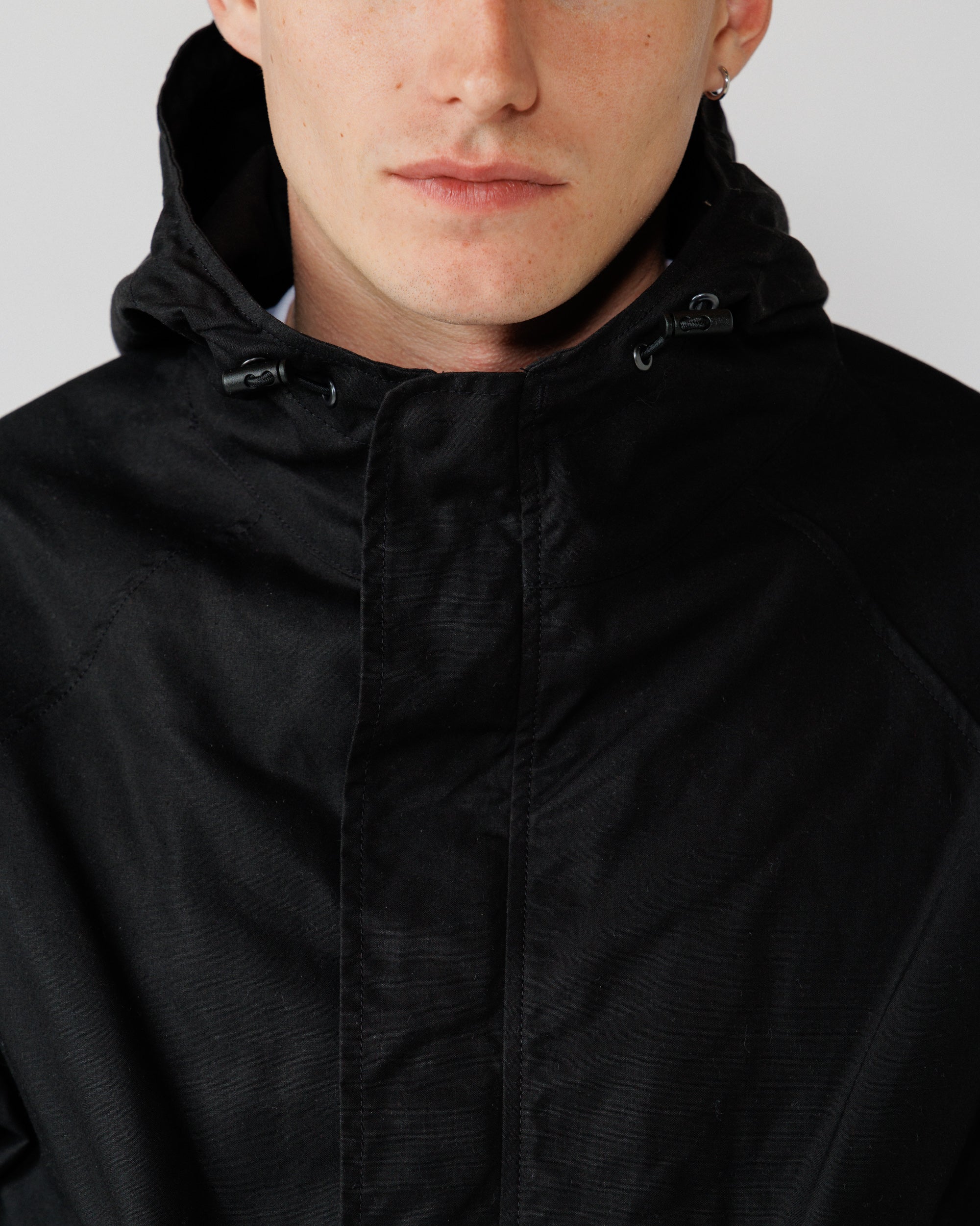 Roam Raglan Jacket - Black — hood drawcord toggle detail