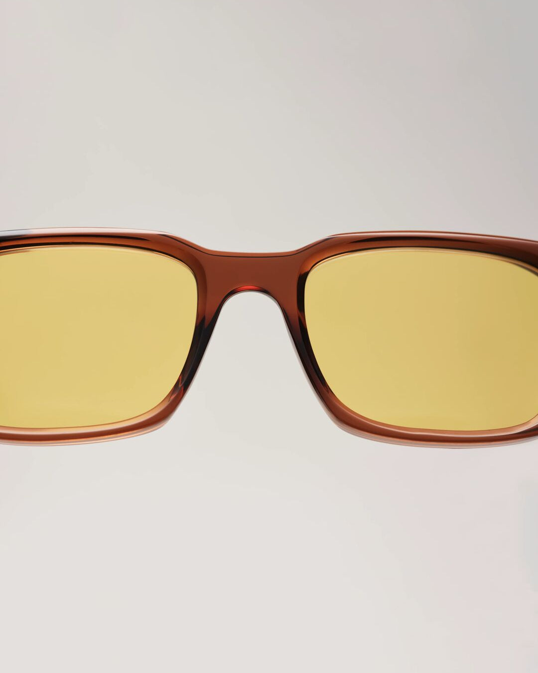 Close-up detail of Solaris Sunglasses coconut acetate frame with yellow tinted lenses