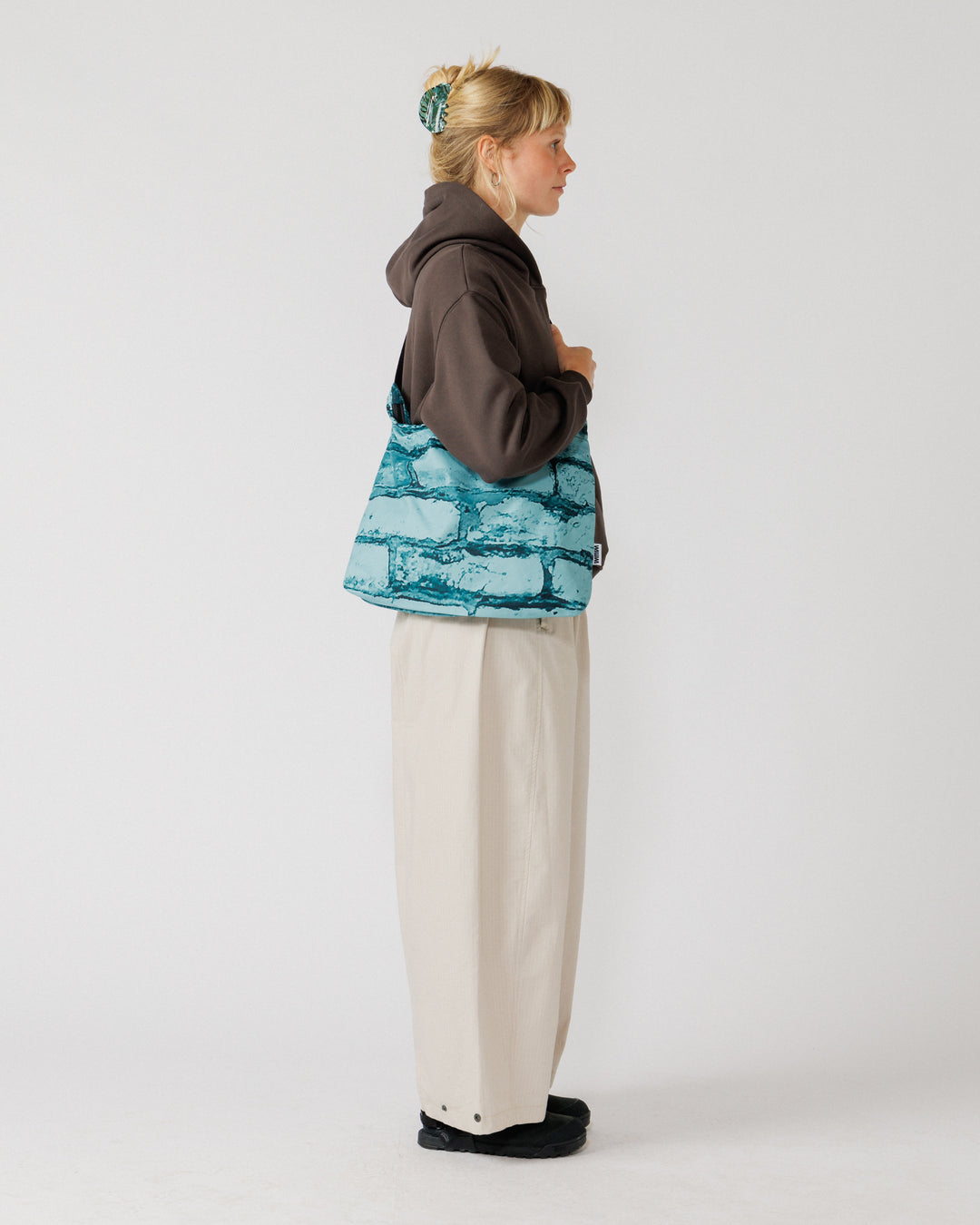 Water Resistant Messenger Bag - Blue Brick Camo — side view, bag drape clearest