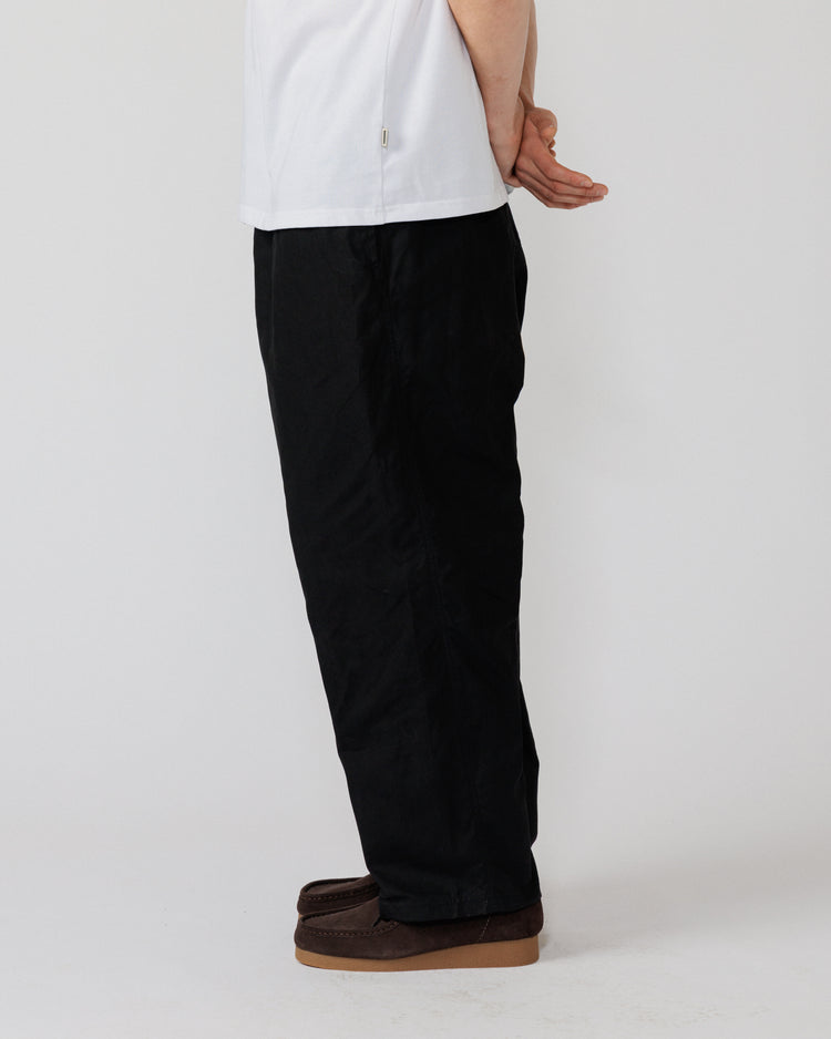 Water Resistant Zama Pants - Black — rear-quarter view leg drape